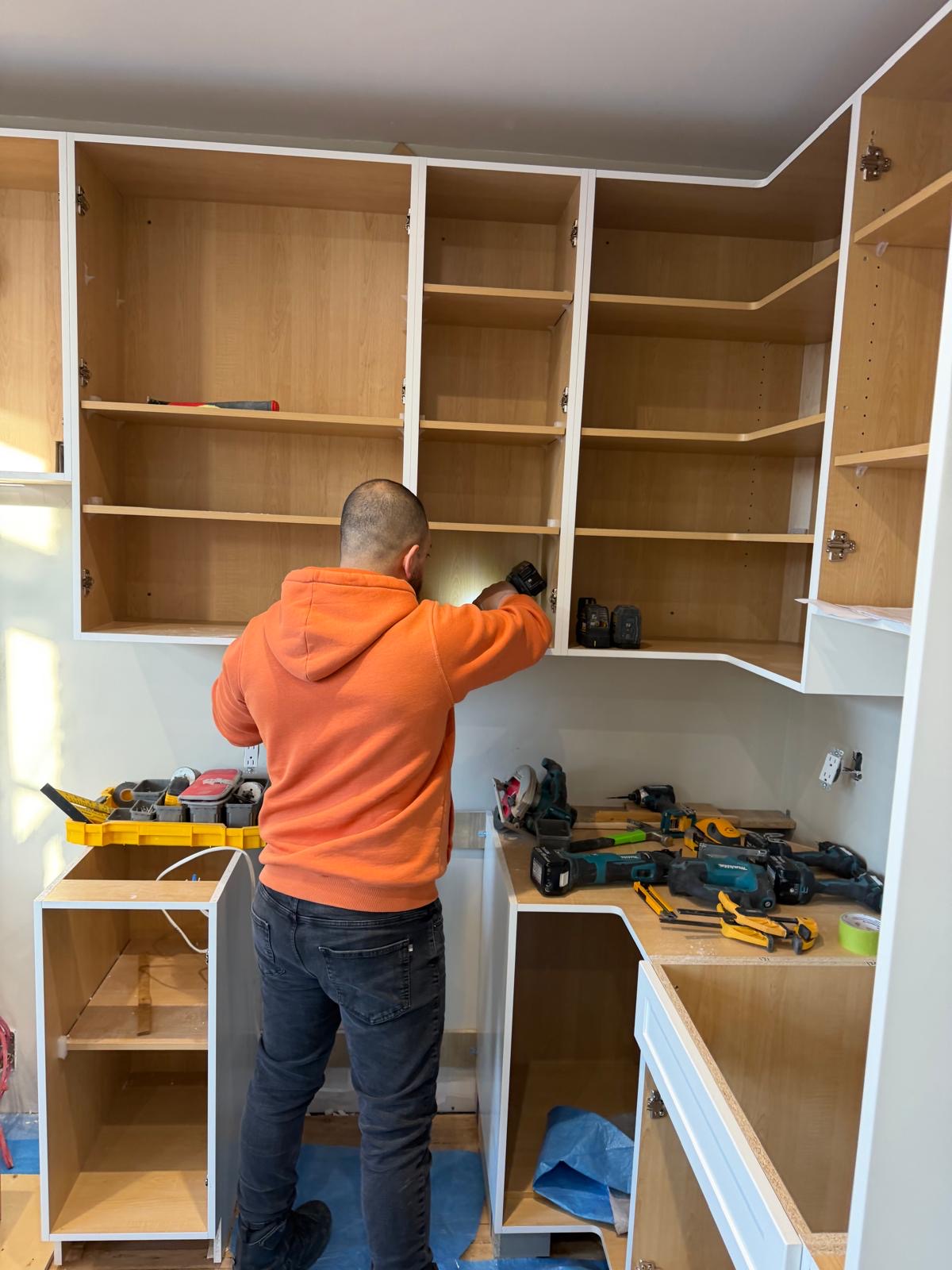 Forma Cuisine craftsman installing custom upper cabinets