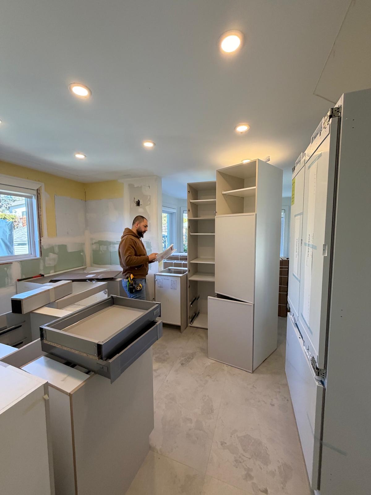 Forma Cuisine craftsman reviewing plans during a kitchen installation